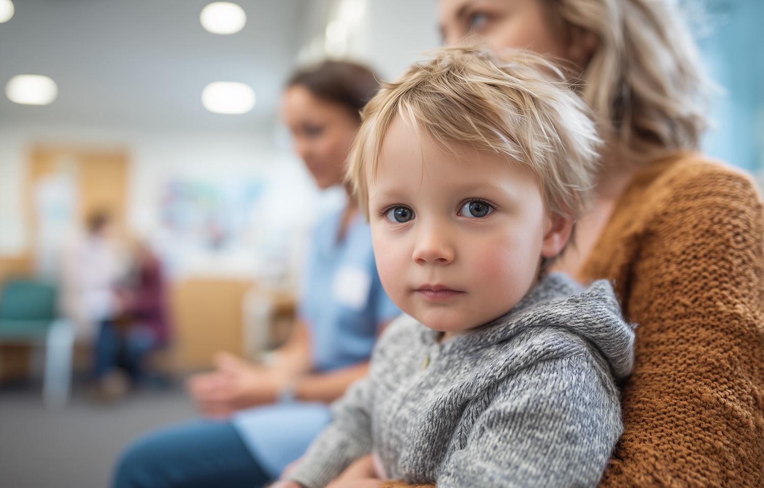 Small Boy Sat with Mother and Nurse